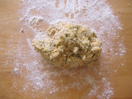 Add wet ingredients into flour ingredients and gently mix to combine the ingredients.  Mix just enough so the dough is sticky and then place it on to a floured board.  Be sure to cover both sides with the flour.
