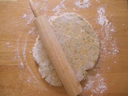 With a floured rolling pin, roll your dough out to a disc.  Be sure to keep it roughly 1/2 inch thick.