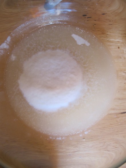 In a separate bowl, proof your yeast using 1/4 C of the warm water and a generous pinch of brown sugar.