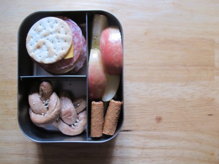 Salami and cheese in crackers, kid made whole wheat pretzels, apple slices, and two whole wheat fig bars for dessert.