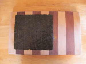 Sheet of seaweed.  Comes in packs of 10-12 for less than $3 in these parts.  I'm sure that you can buy it online.