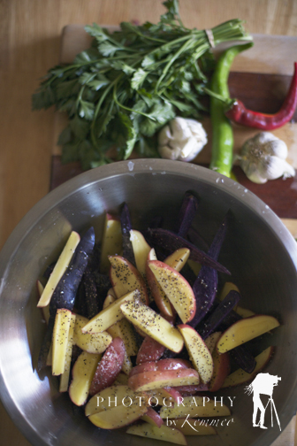 Slice potatoes lengthwise.  Season with salt and pepper and 2 Tbs. olive oil and then stir it all up in the bowl.
